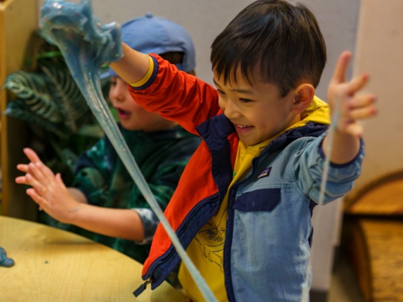 students having fun playing with slime