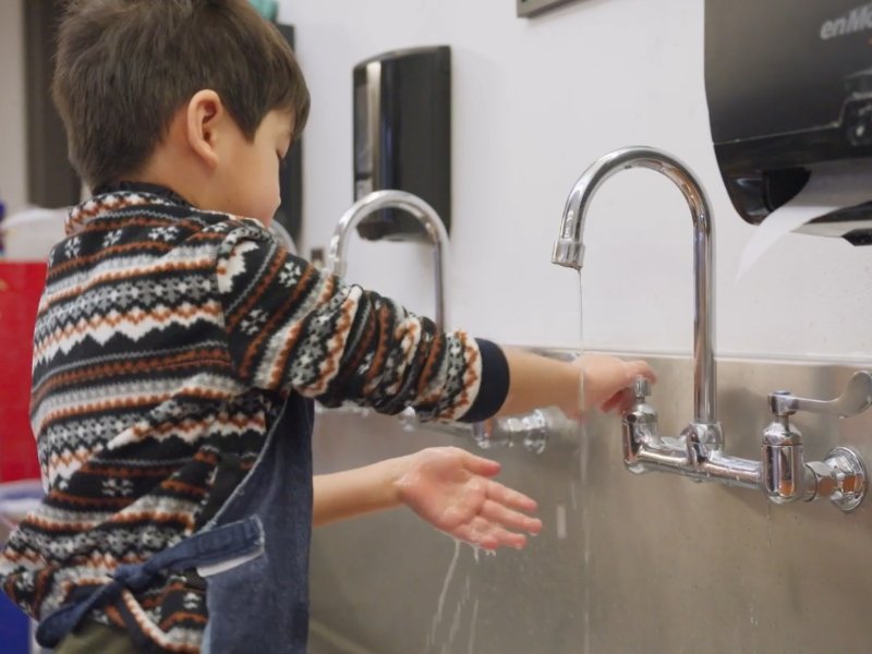 student washing hands