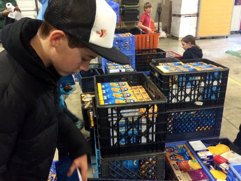 students collecting donated food for a food bank 