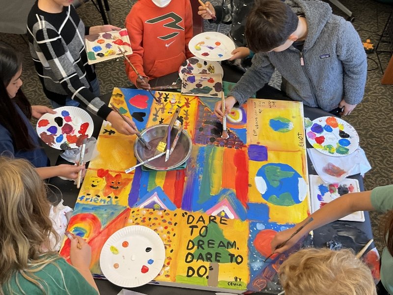 students painting an acceptance mural