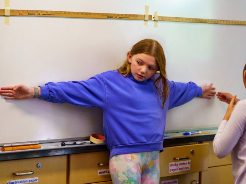 students measuring wingspan