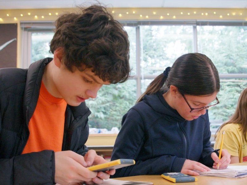 middle school students working intently on math with calculators