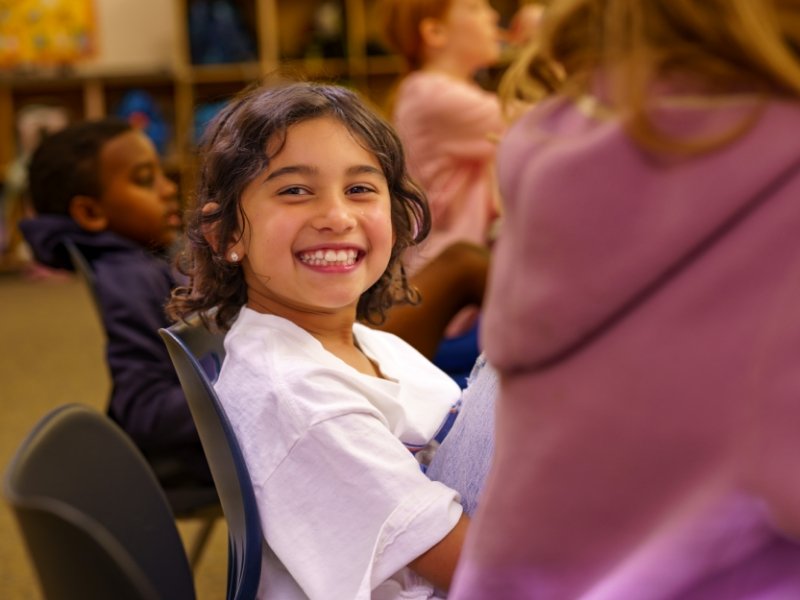 student in class smiling