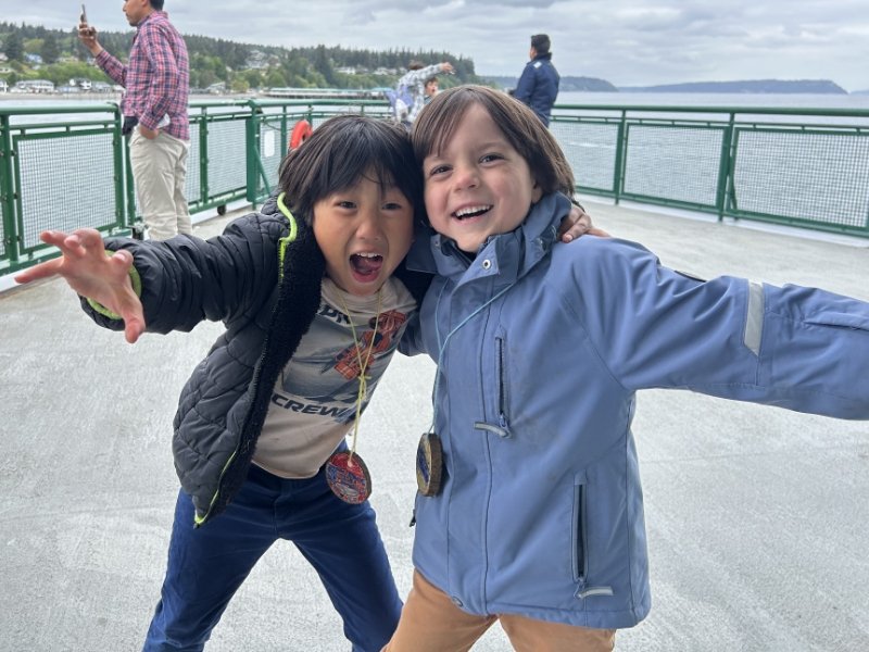 students smiling and posing on a ferry in Puget Sound during a field trip