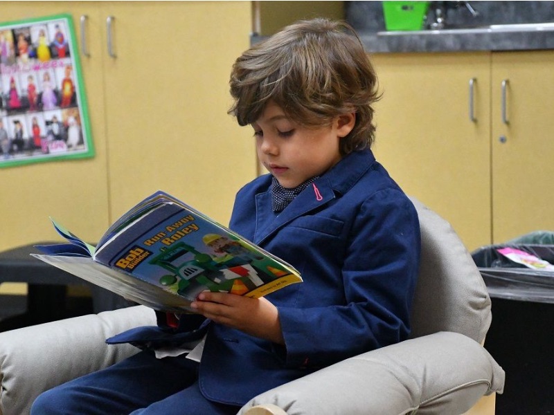 Student reading in a comfy chair